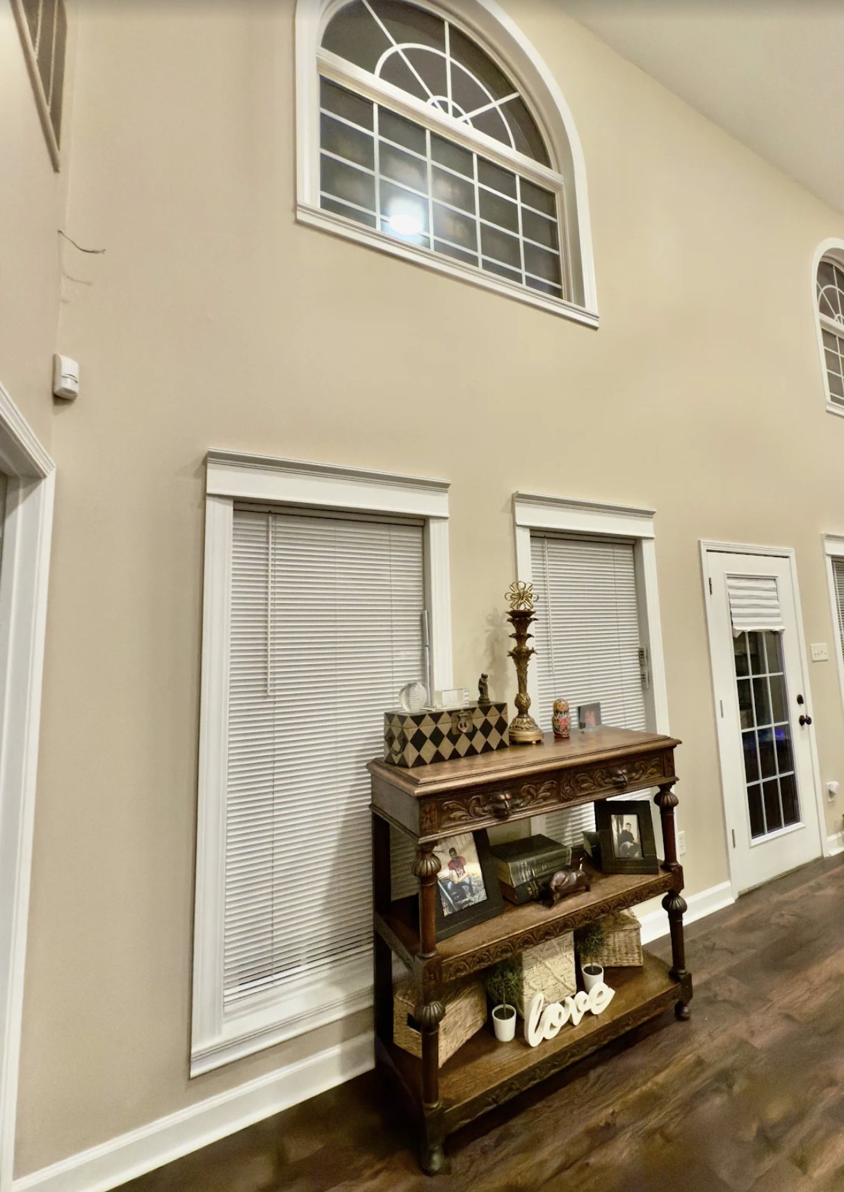 Two-story entry and stairwell painted in warm cream with white trim, Little Rock